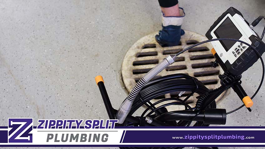 Plumber Inspecting Drainage Using Sewer Camera