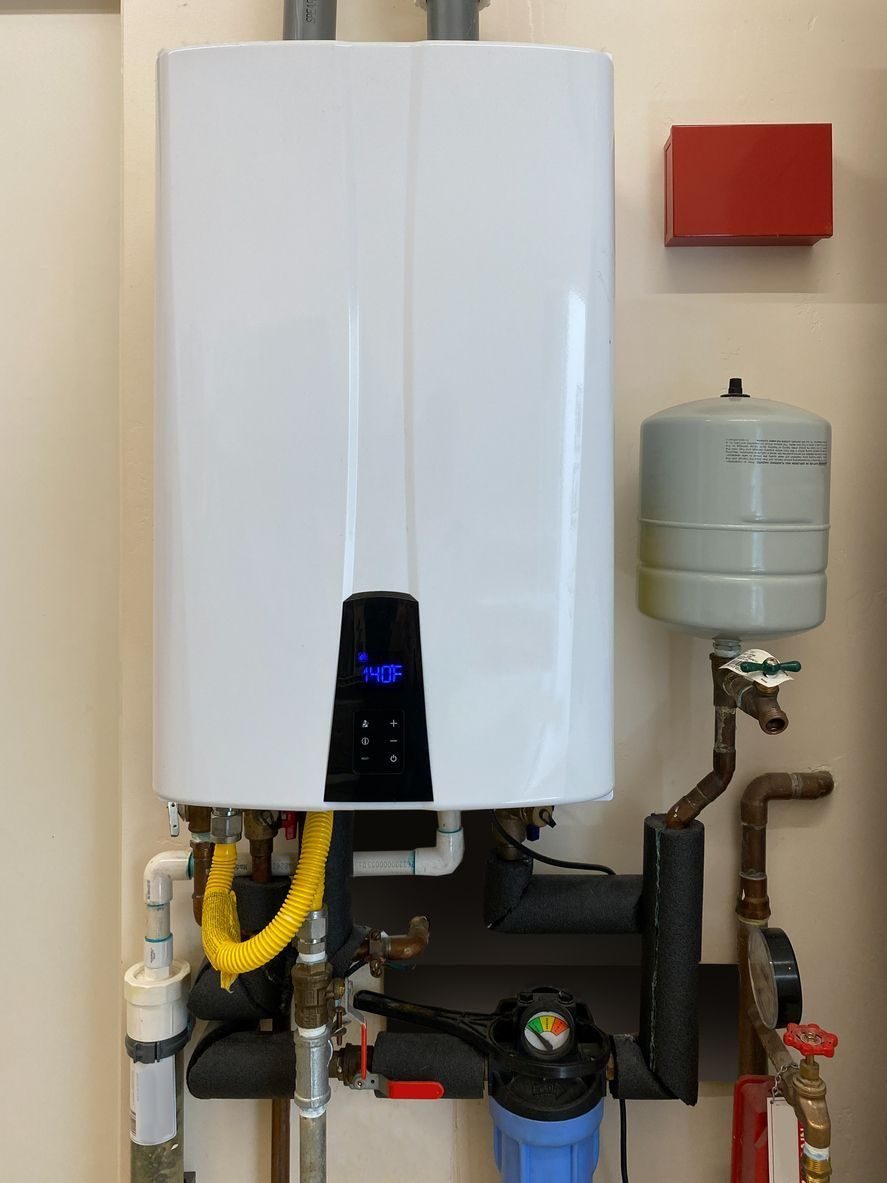 Tankless water heater mounted on the wall in the basement