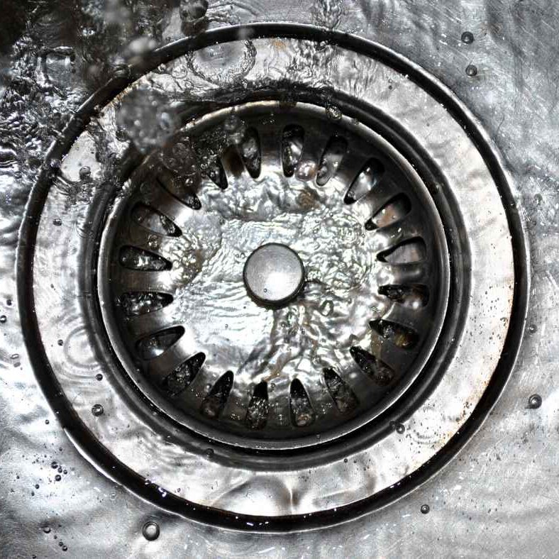 A sink drain with water flowing